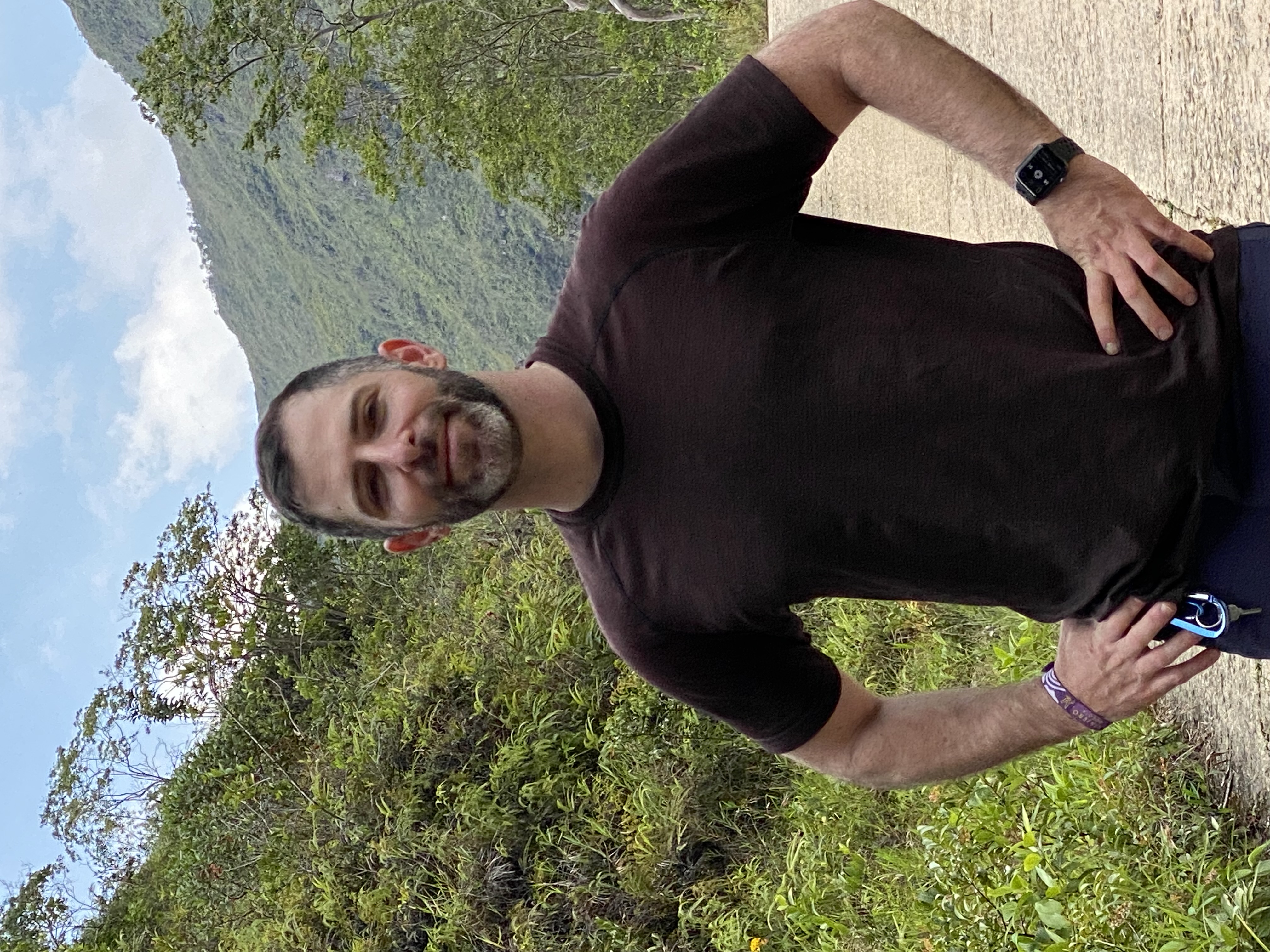 Standing on a mountain path in Peru, hands on hips