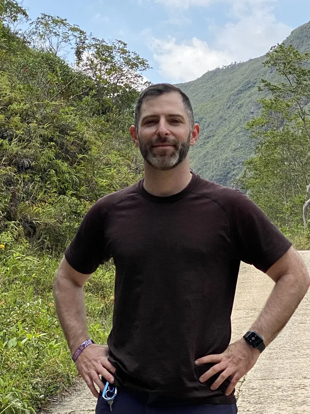 Standing on a mountain path in Peru, hands on hips
